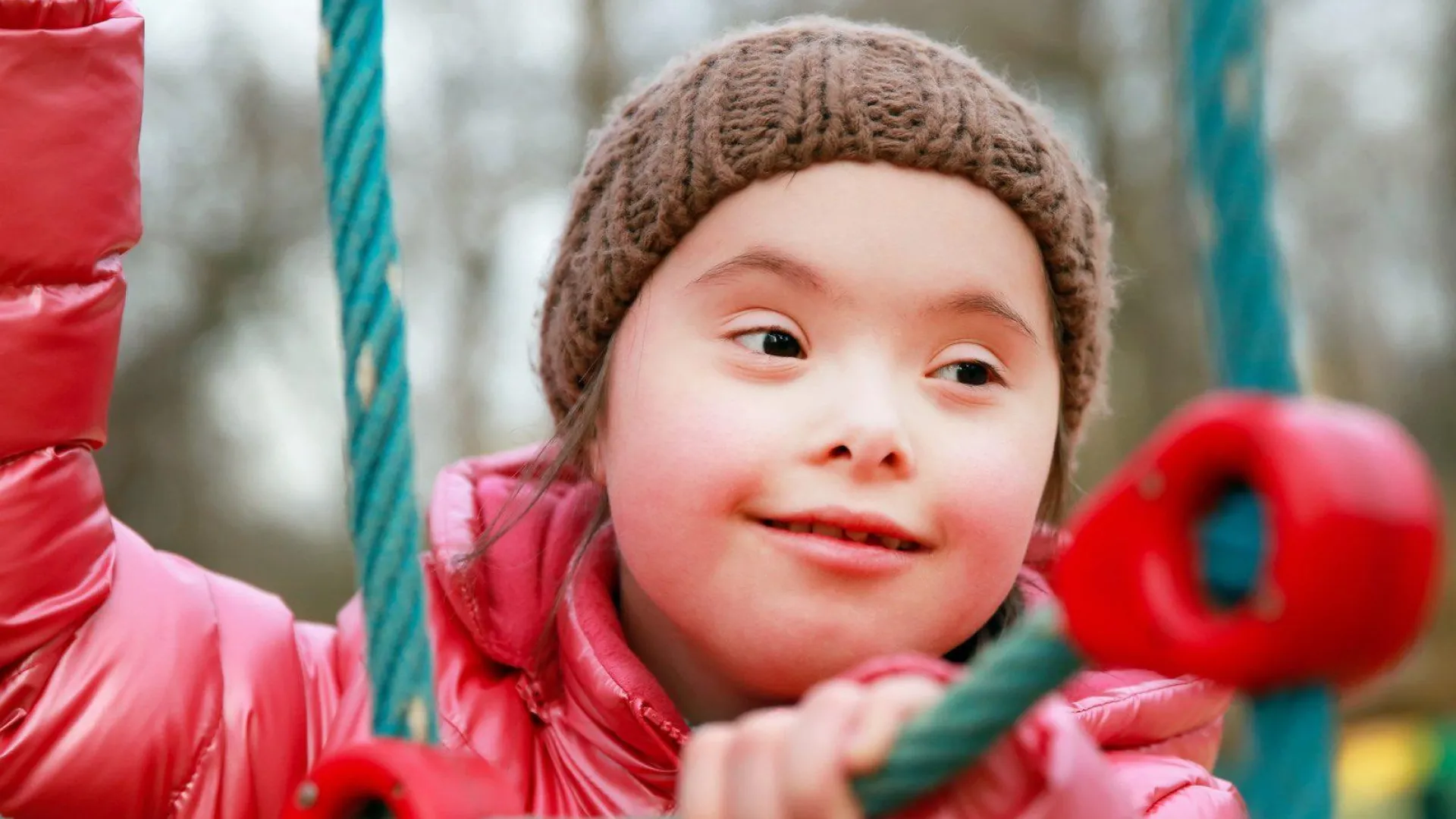 A child with a disability on play equipment