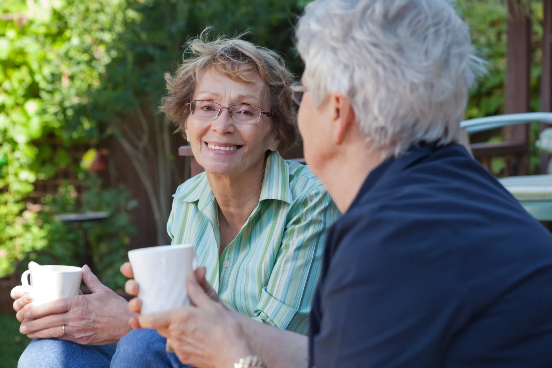 Two elderly women sharing a coffee